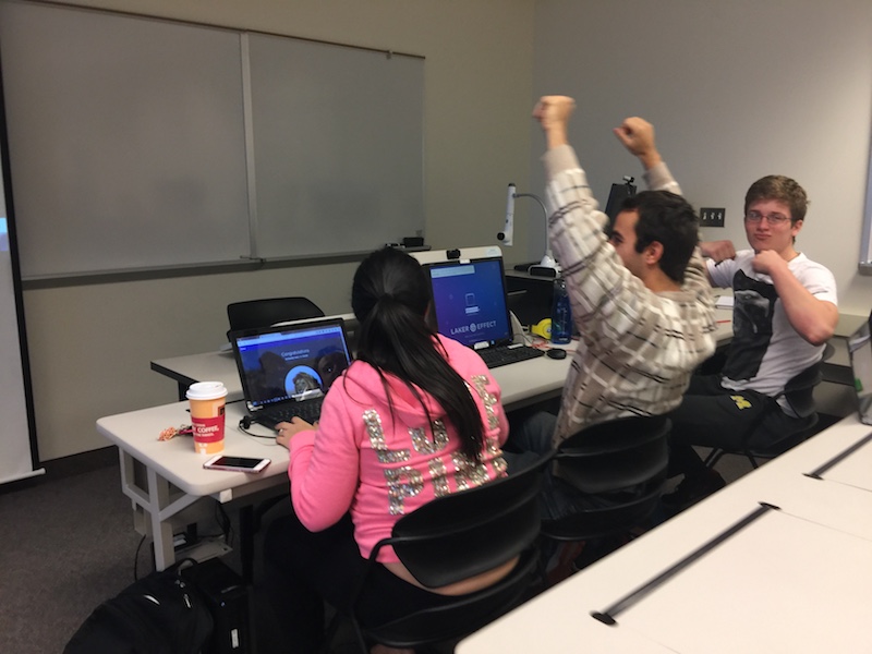 Students raising hands during a gamified class activity